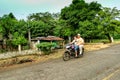 Couple on a motor bike on a dirt road